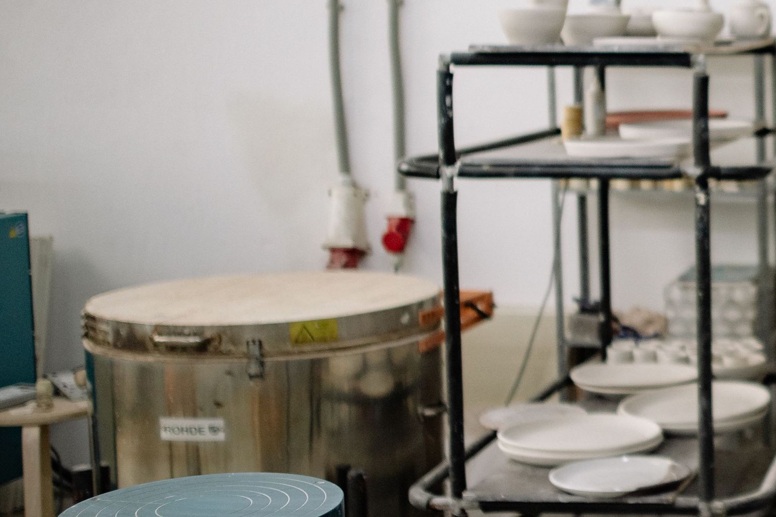 The studio: the kiln and a trolley of plates.