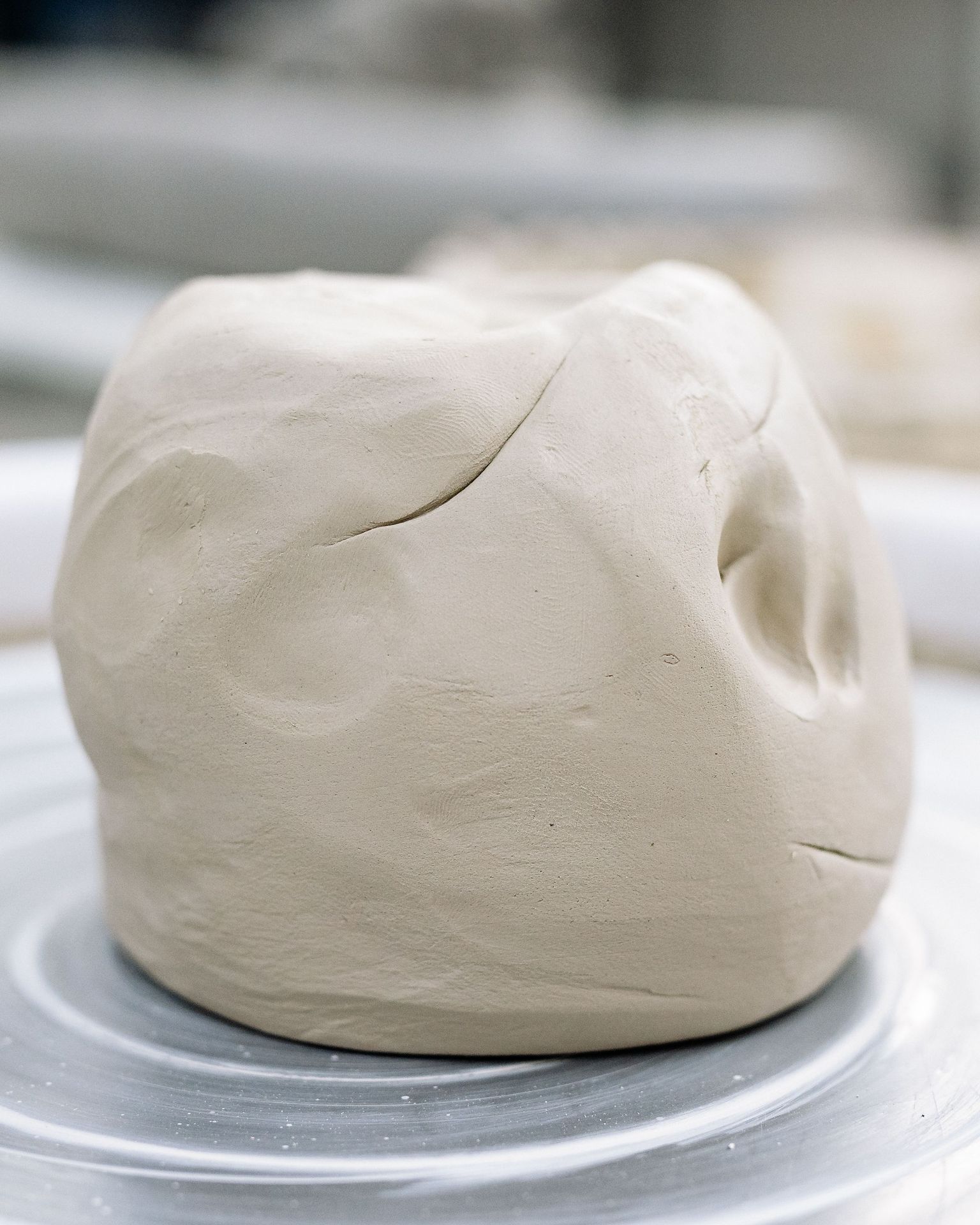 A lump of wedged clay on the wheel.