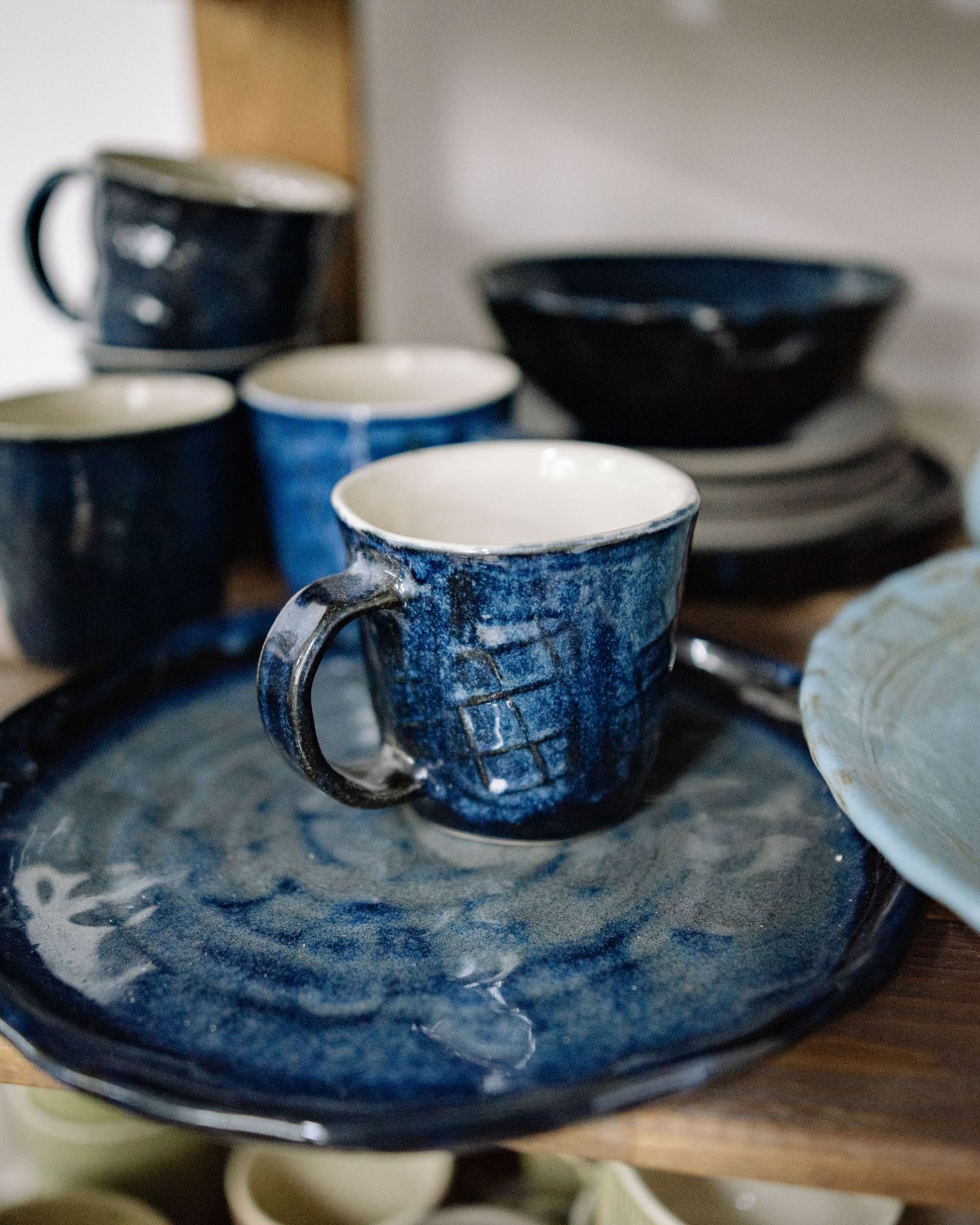 A finished mug with a glossy deep blue glaze.